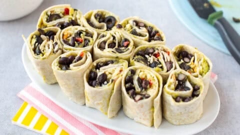 Tex-Mex tortilla roll-ups on a plate.