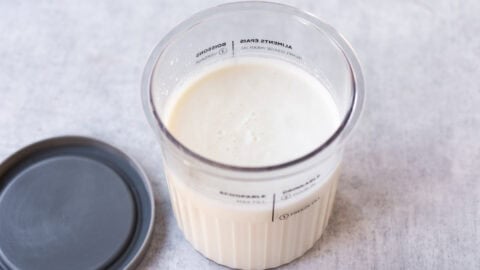 Cottage cheese mixture in a Ninja Creami tub.