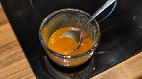 A small bowl of tahini and soy dressing.