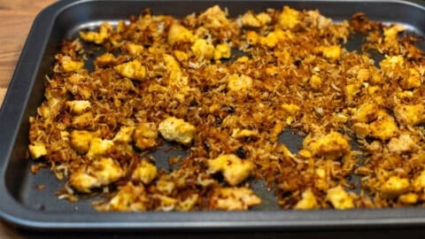 Crispy rice and tofu on a baking tray.