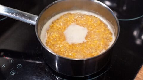 Red lentils cooking in a saucepan.