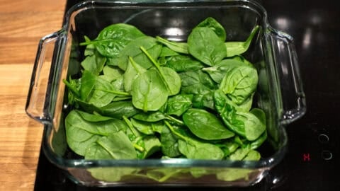 Spinach laid out in a baking dish.