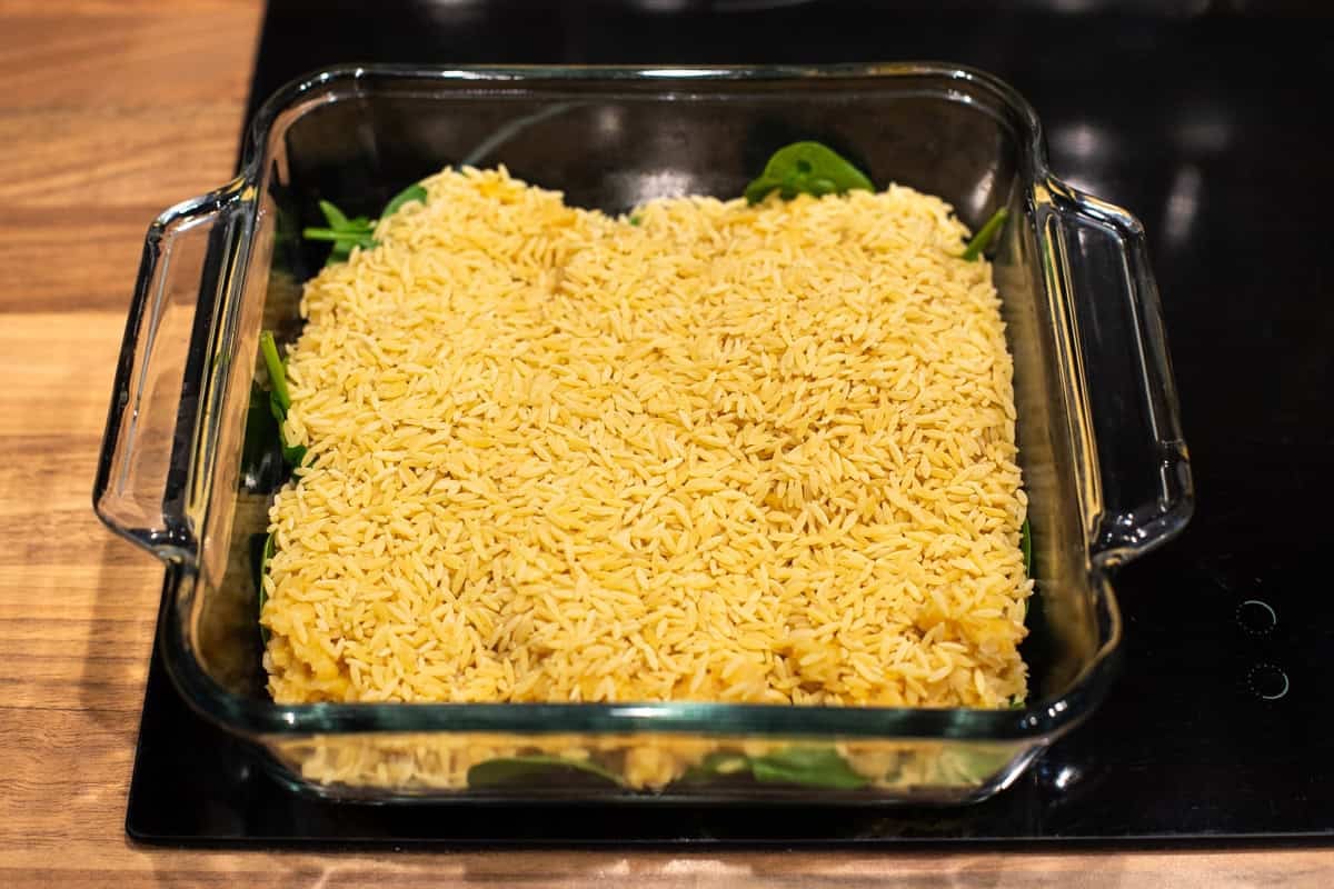 Uncooked orzo in a baking dish.