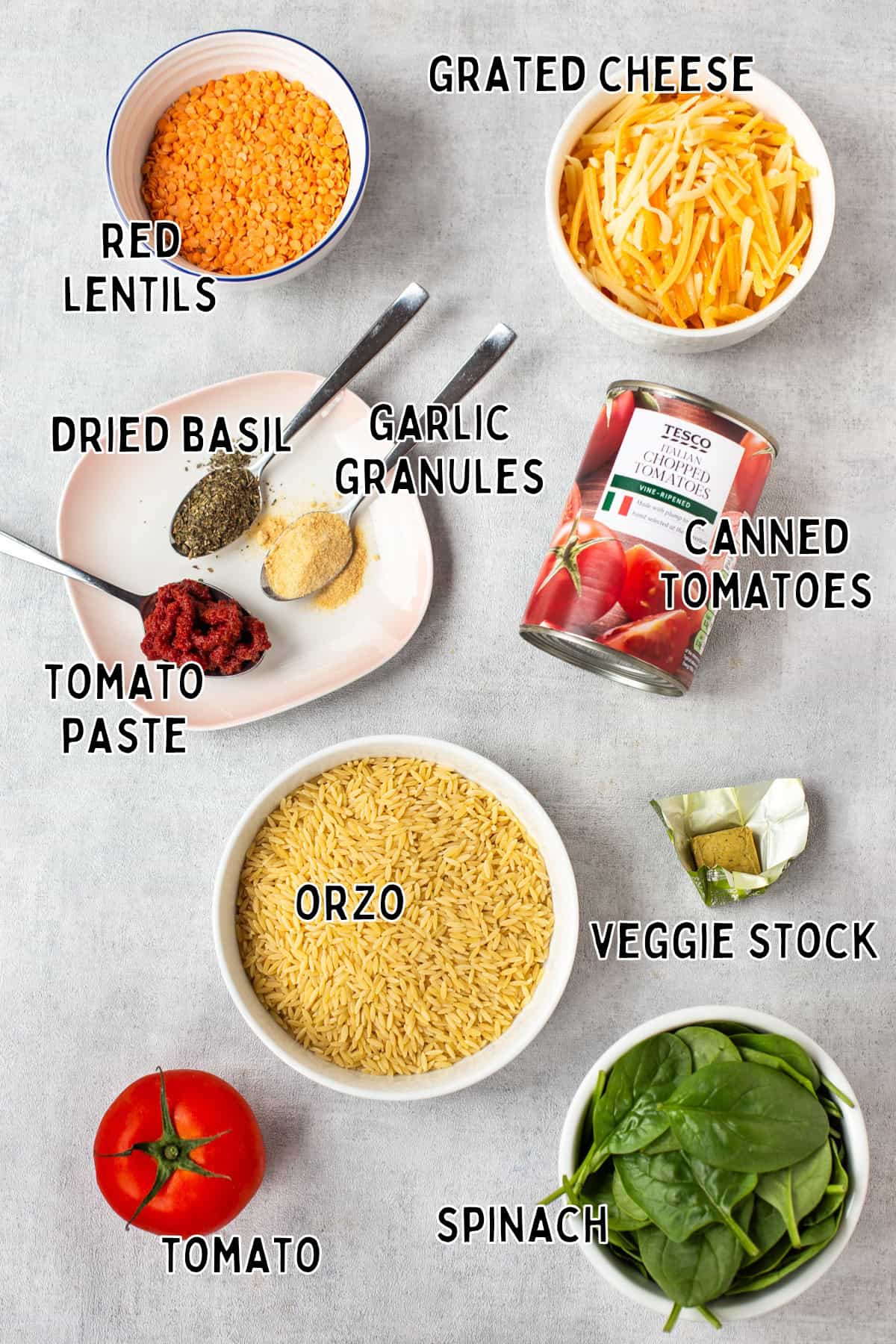 Ingredients for cheese and tomato baked orzo laid out with text overlay.