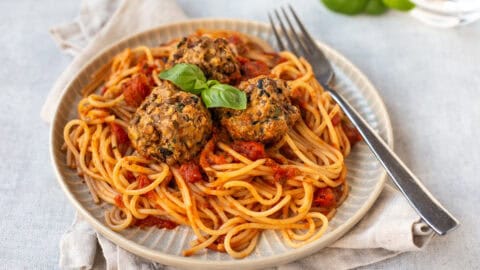 A plate of spaghetti served with Mediterranean lentil meatballs.
