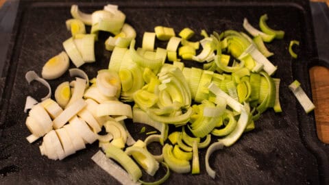 Sliced leeks on a chopping board.