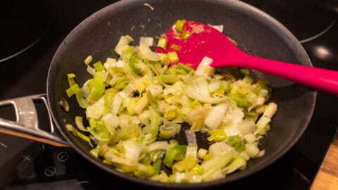 A frying pan of sautéed leeks.