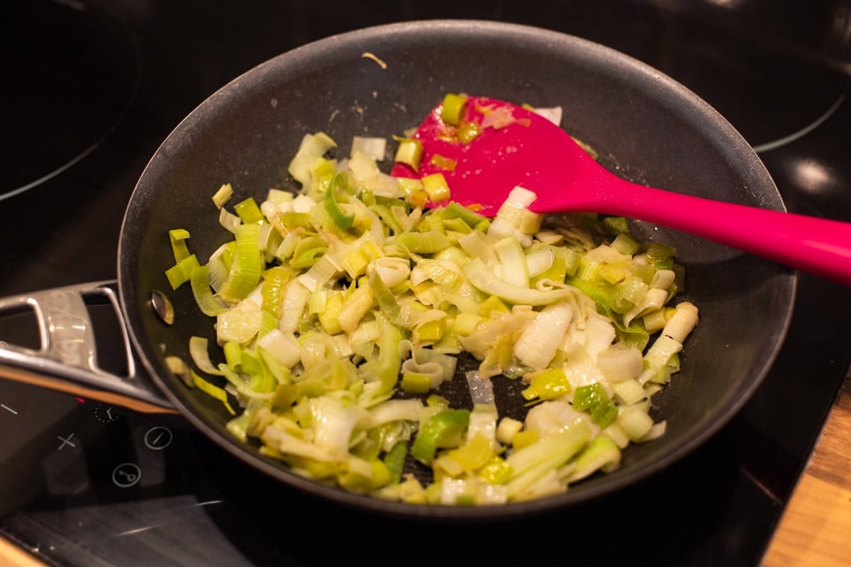 A frying pan of sautéed leeks.