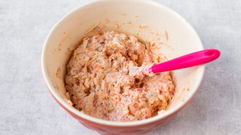 A mixing bowl full of a vegetable cream cheese mixture.