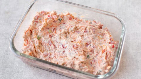 Veggie cream cheese in a rectangular glass dish.