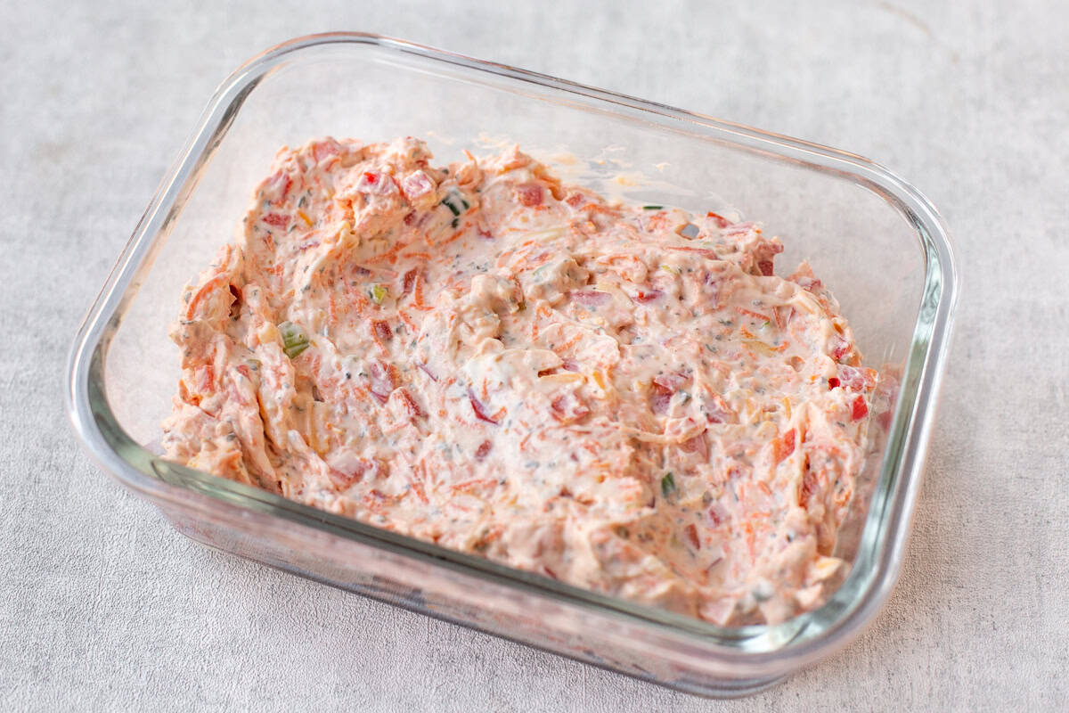 Veggie cream cheese in a rectangular glass dish.