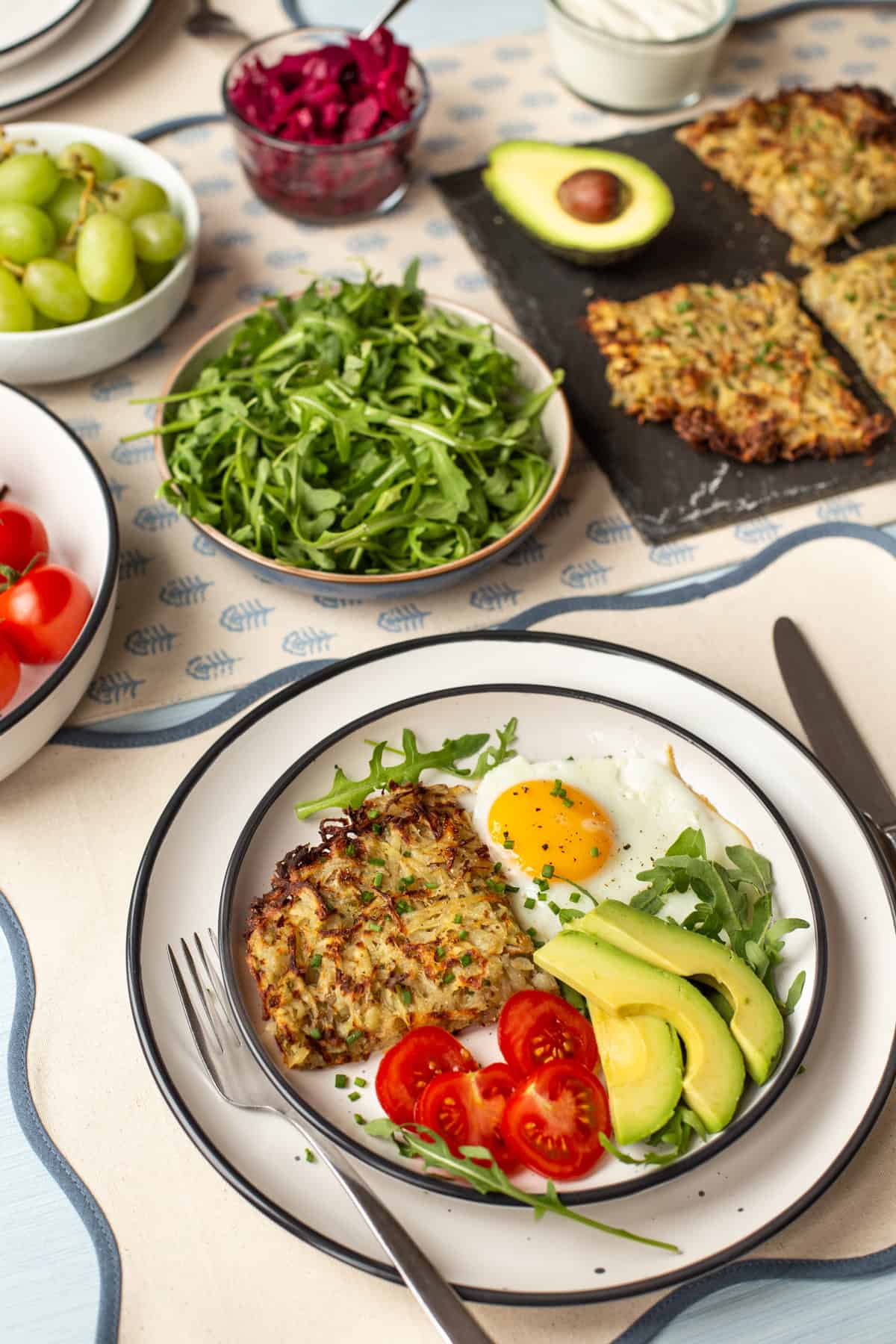 An easy vegetarian brunch spread, with hash browns, fried eggs, vegetables, etc.