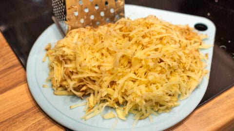 Grated potato on a cutting board.