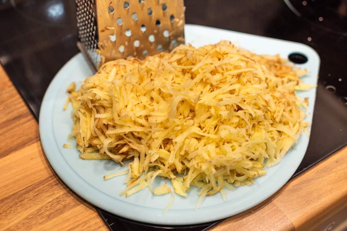 Grated potato on a cutting board.