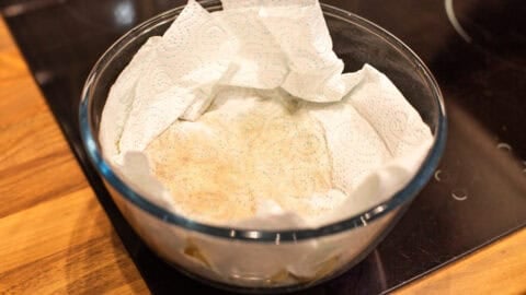 Grated potato in a bowl with kitchen paper.
