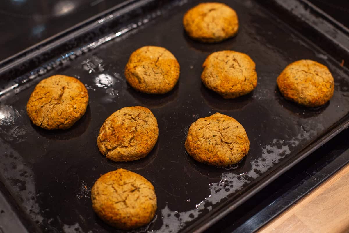 Homemade baked falafel on a baking tray.