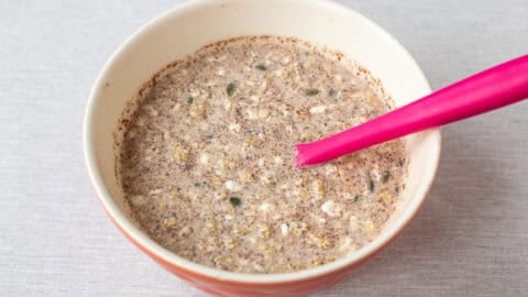Ingredients for high protein overnight oats mixed in a bowl.
