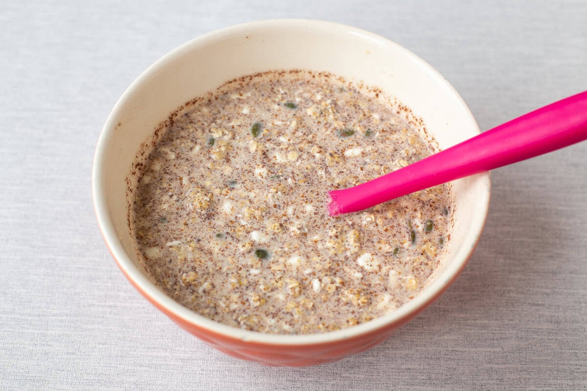 Ingredients for high protein overnight oats mixed in a bowl.