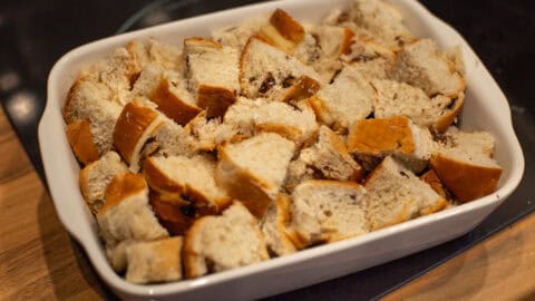 Diced hot cross buns in a baking dish.