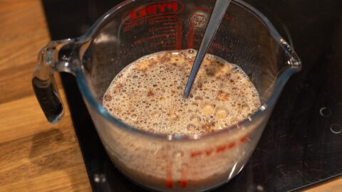 Spiced egg custard mixture in a jug.