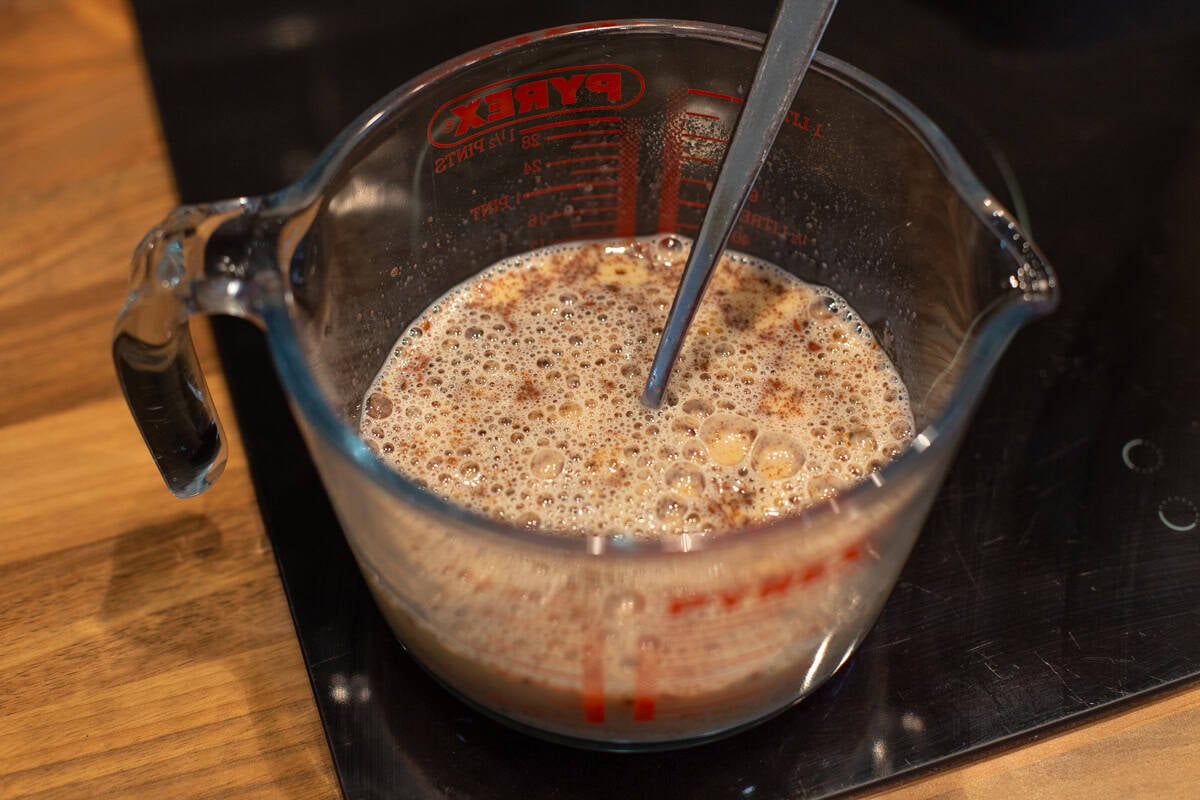 Spiced egg custard mixture in a jug.