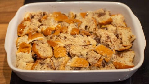 Diced hot cross buns in a dish, soaked in egg custard.