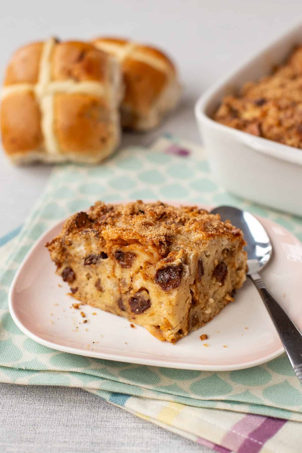 A piece of hot cross bun bread pudding on a plate.