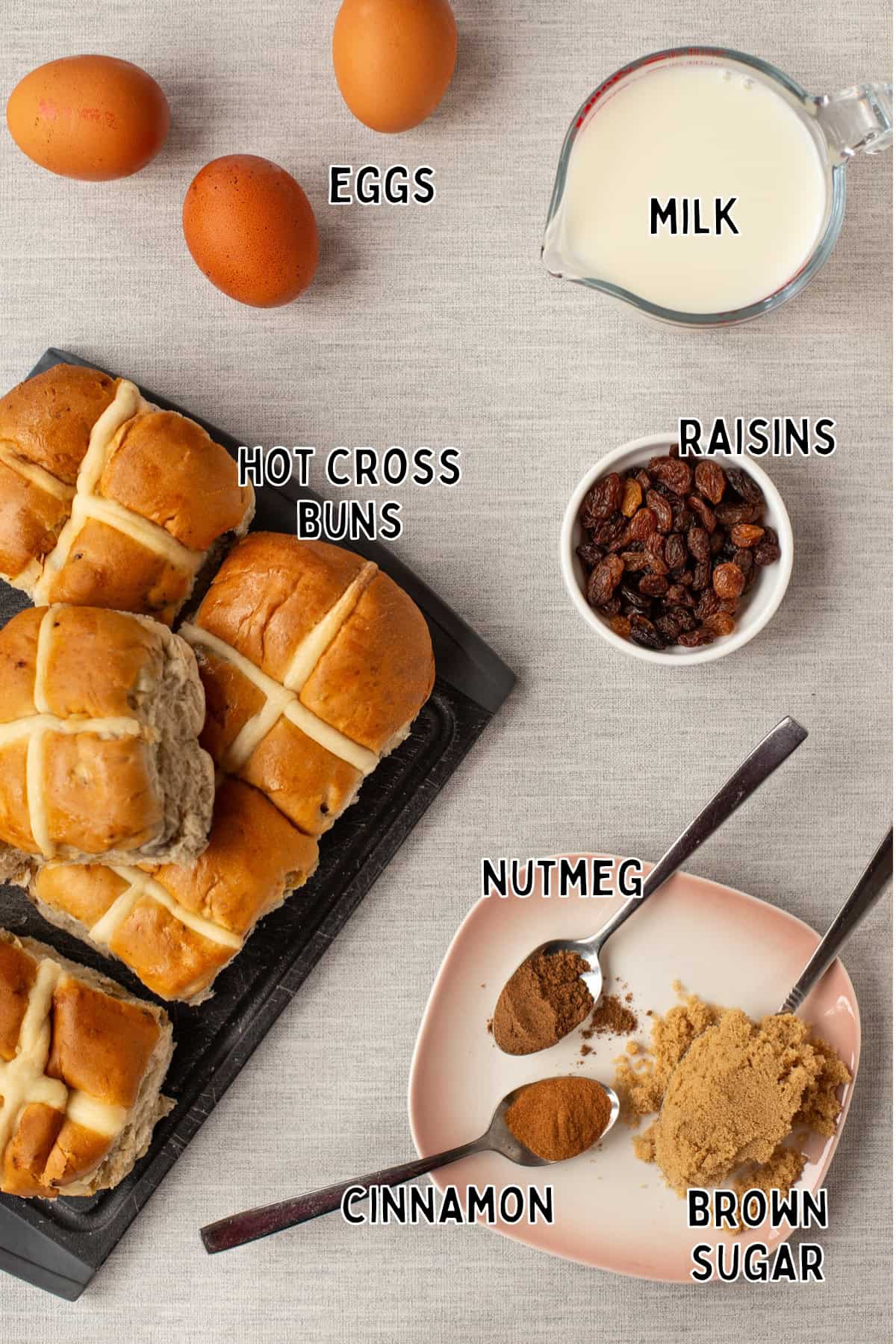 Ingredients for hot cross bun bread and butter pudding laid out with text overlay.