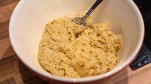 Uncooked cheese scone mixture in a mixing bowl.