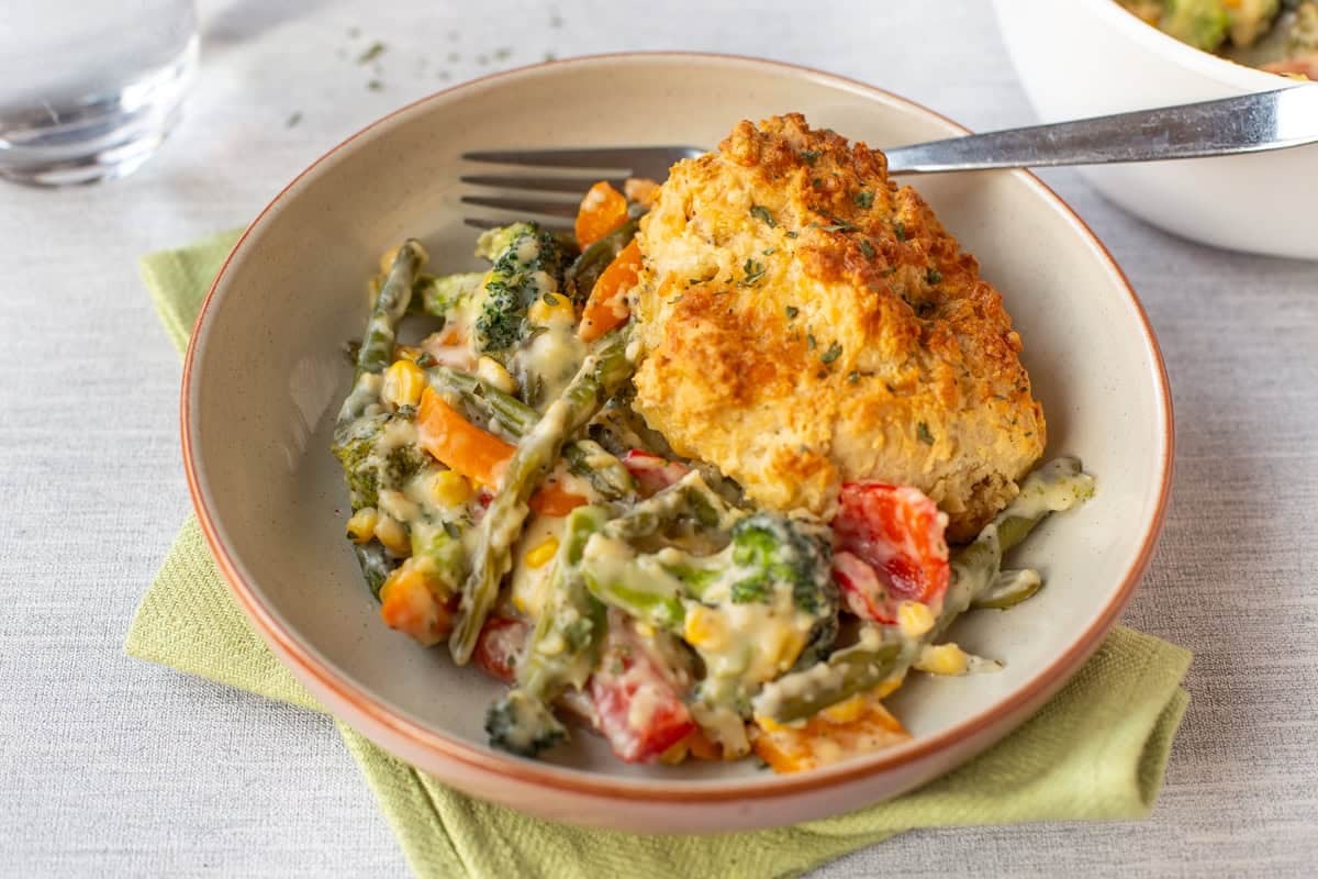 Vegetable cobbler topped with crispy cheese scone.