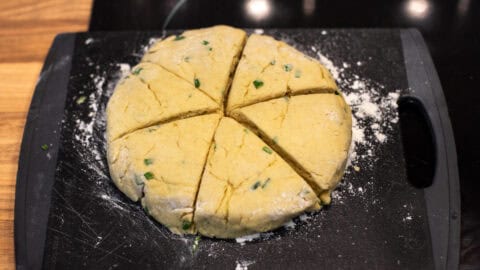 Homemade scone dough cut into triangles.