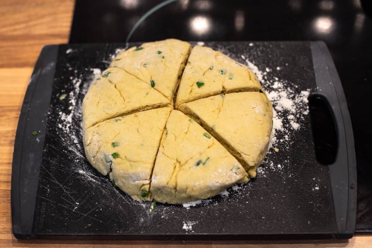 Homemade scone dough cut into triangles.