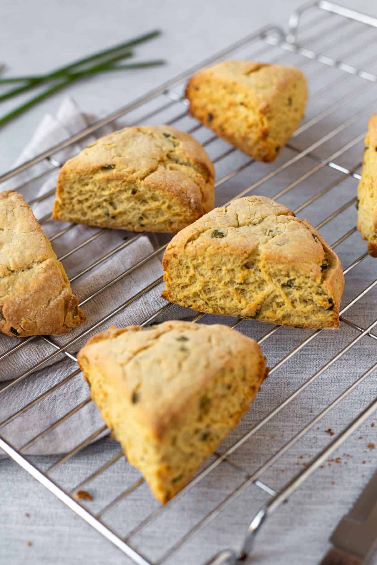 Easy homemade hummus scones spread out on a cooling rack.