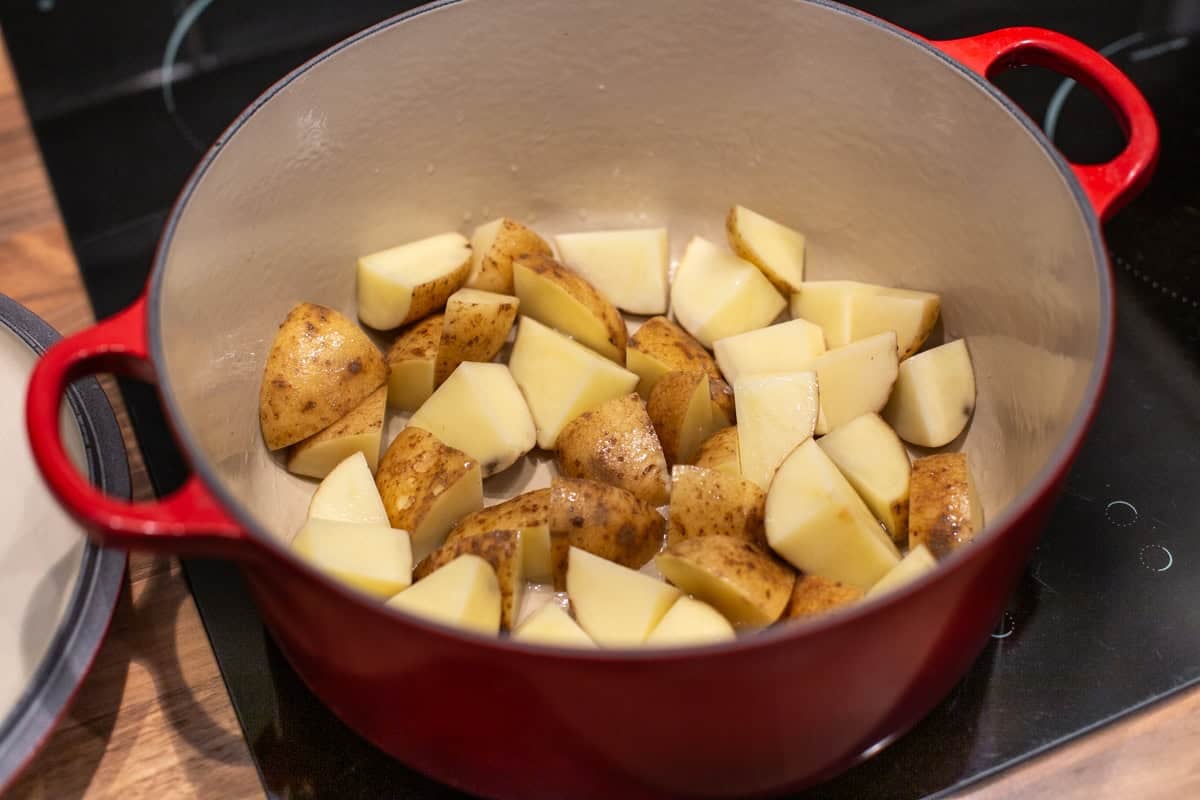 Chopped potatoes in a large pot.