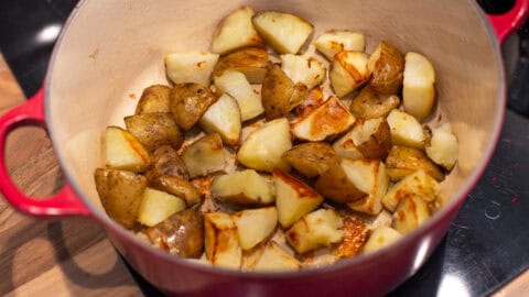 Roasted potatoes in a large pot.