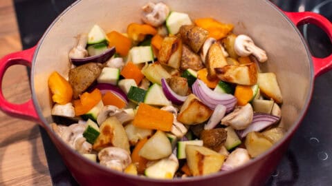 Roasted veggies in a large pot.