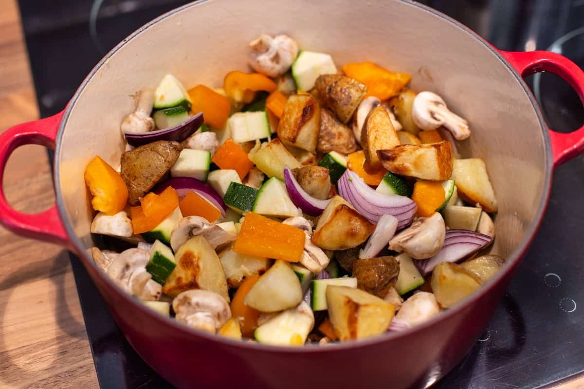 Roasted veggies in a large pot.