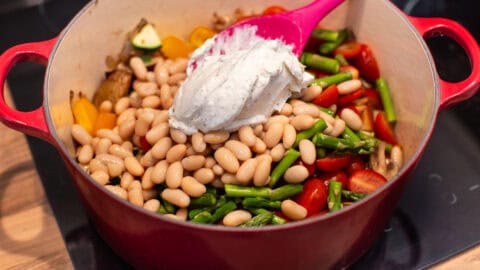 Cream cheese, beans and vegetables in a big pot.
