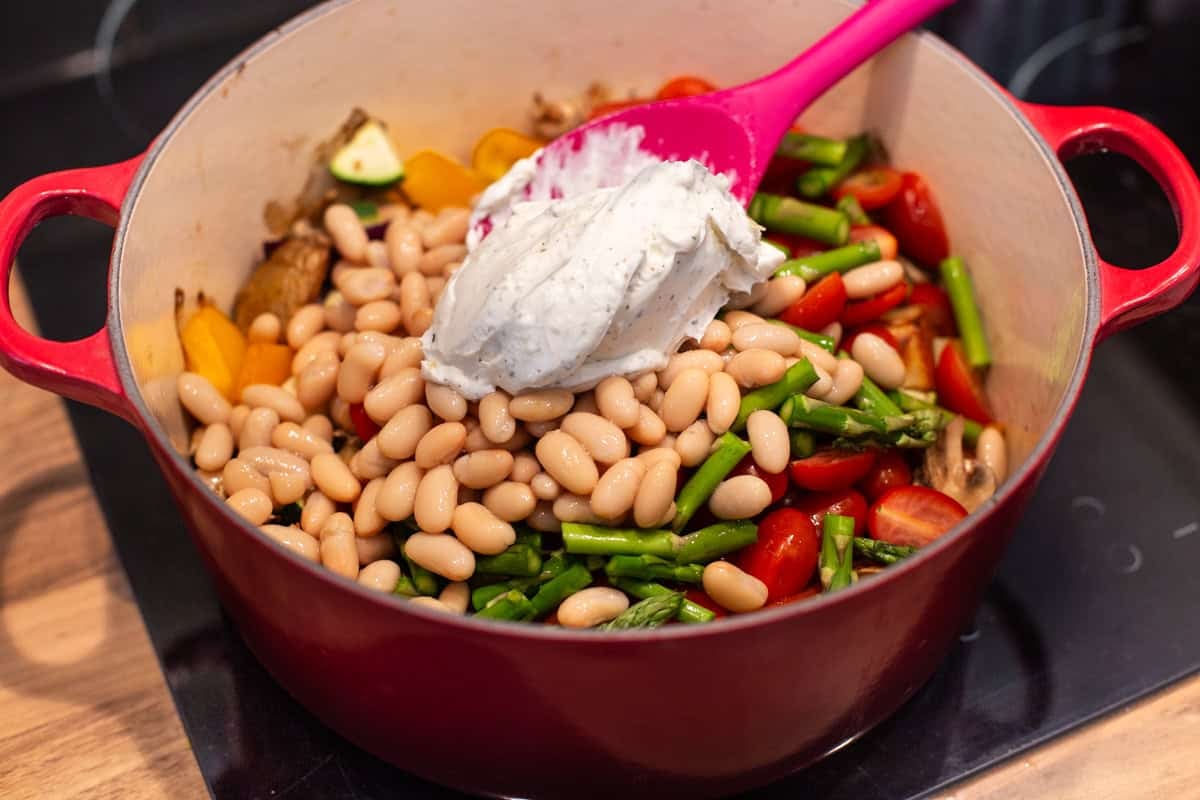 Cream cheese, beans and vegetables in a big pot.