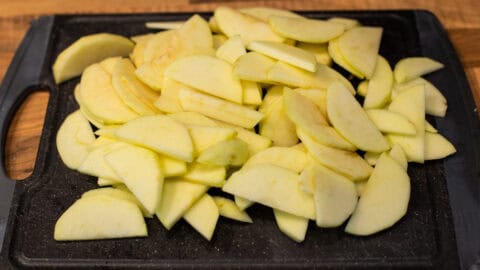 Sliced cooking apples on a cutting board.