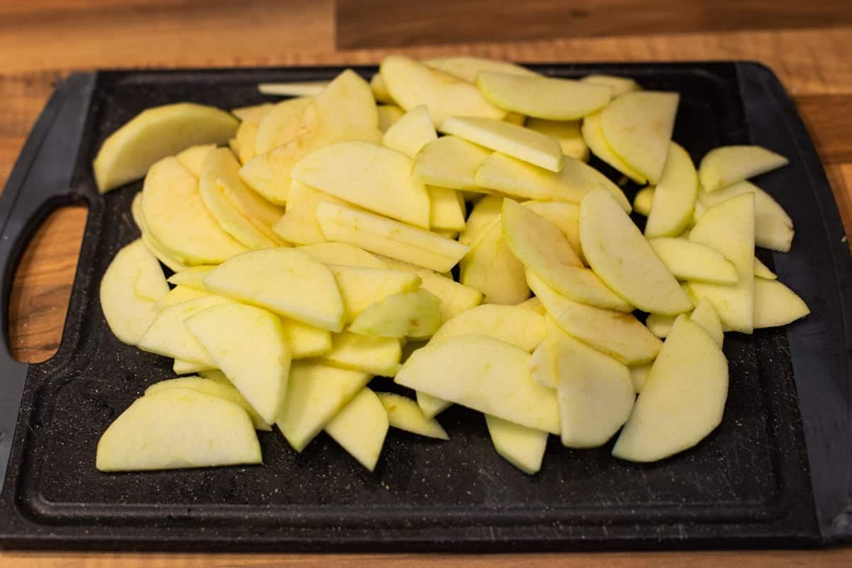 Sliced cooking apples on a cutting board.