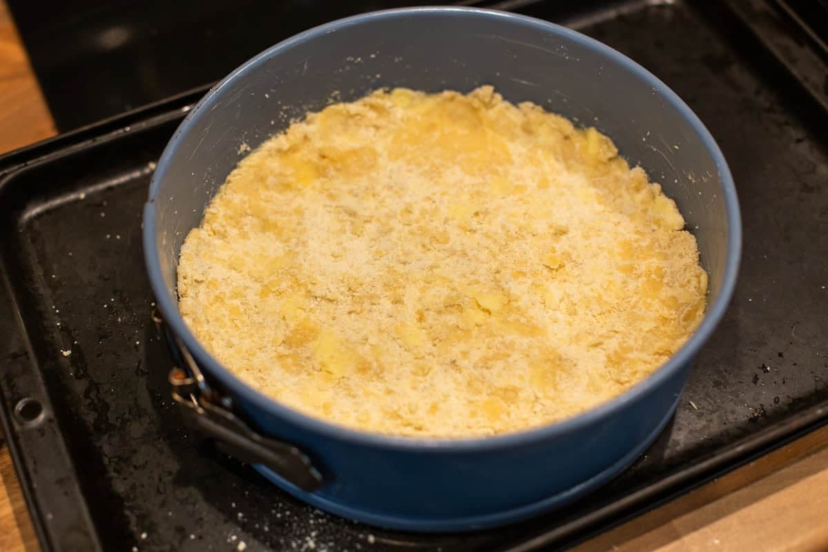 Easy crumble mixture pressed into a springform cake tin.