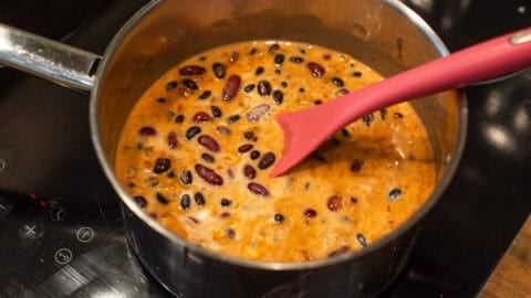 Kidney beans and coconut milk with spices in a saucepan.