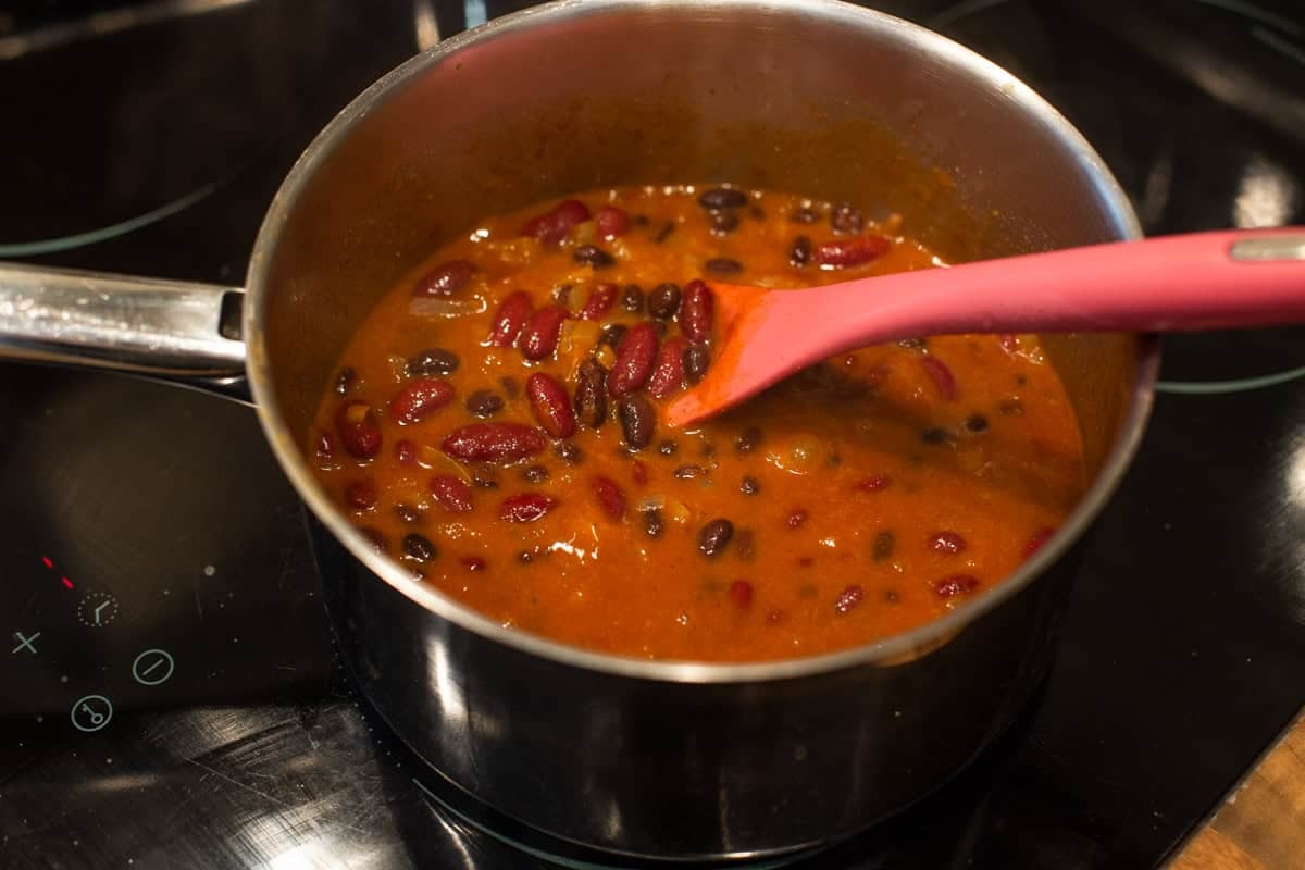 Easy kidney bean curry cooking in a saucepan.