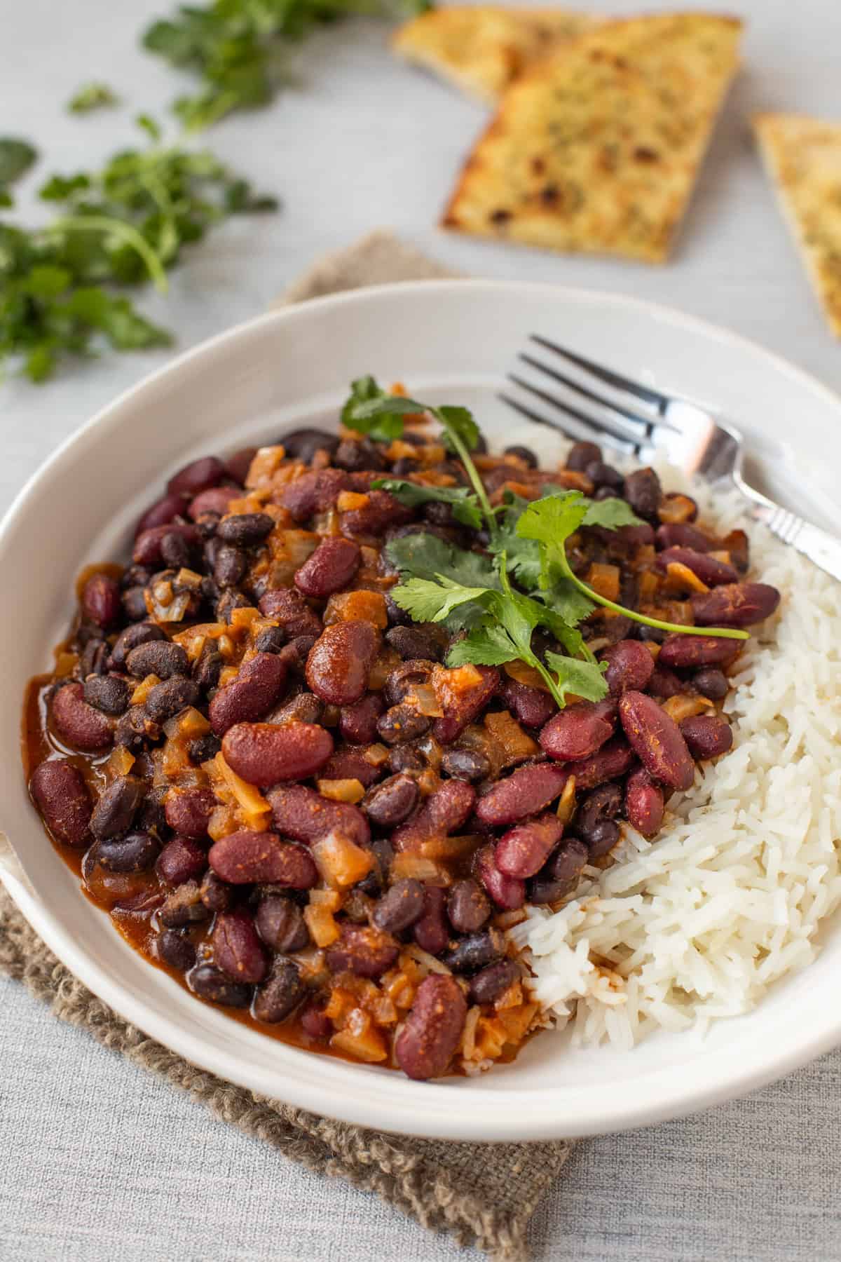 A bowl of vegetarian bean curry with rice.