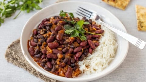Easy kidney bean curry served in a bowl with rice and cilantro.
