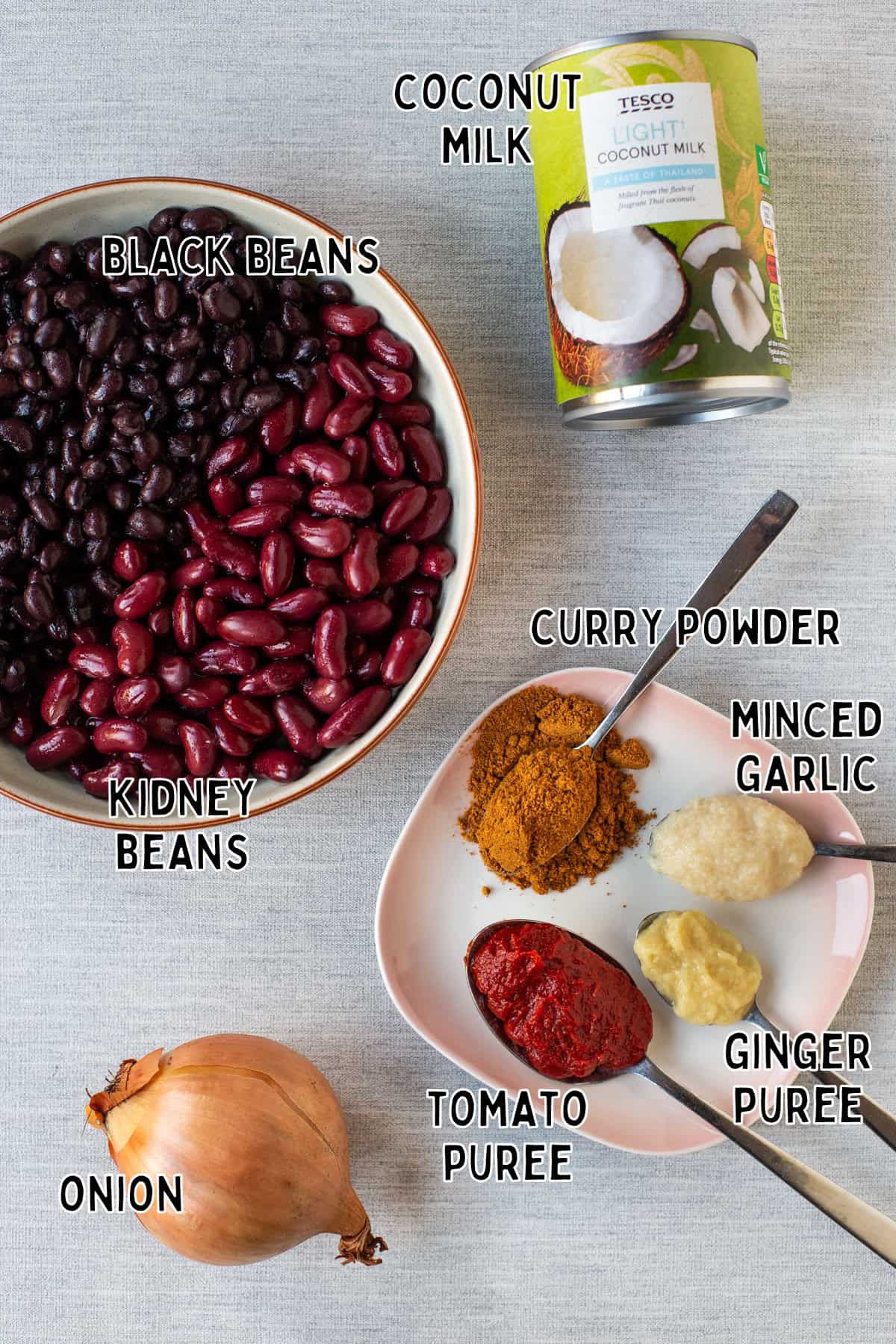 Ingredients for easy vegan kidney bean curry laid out with text overlay.