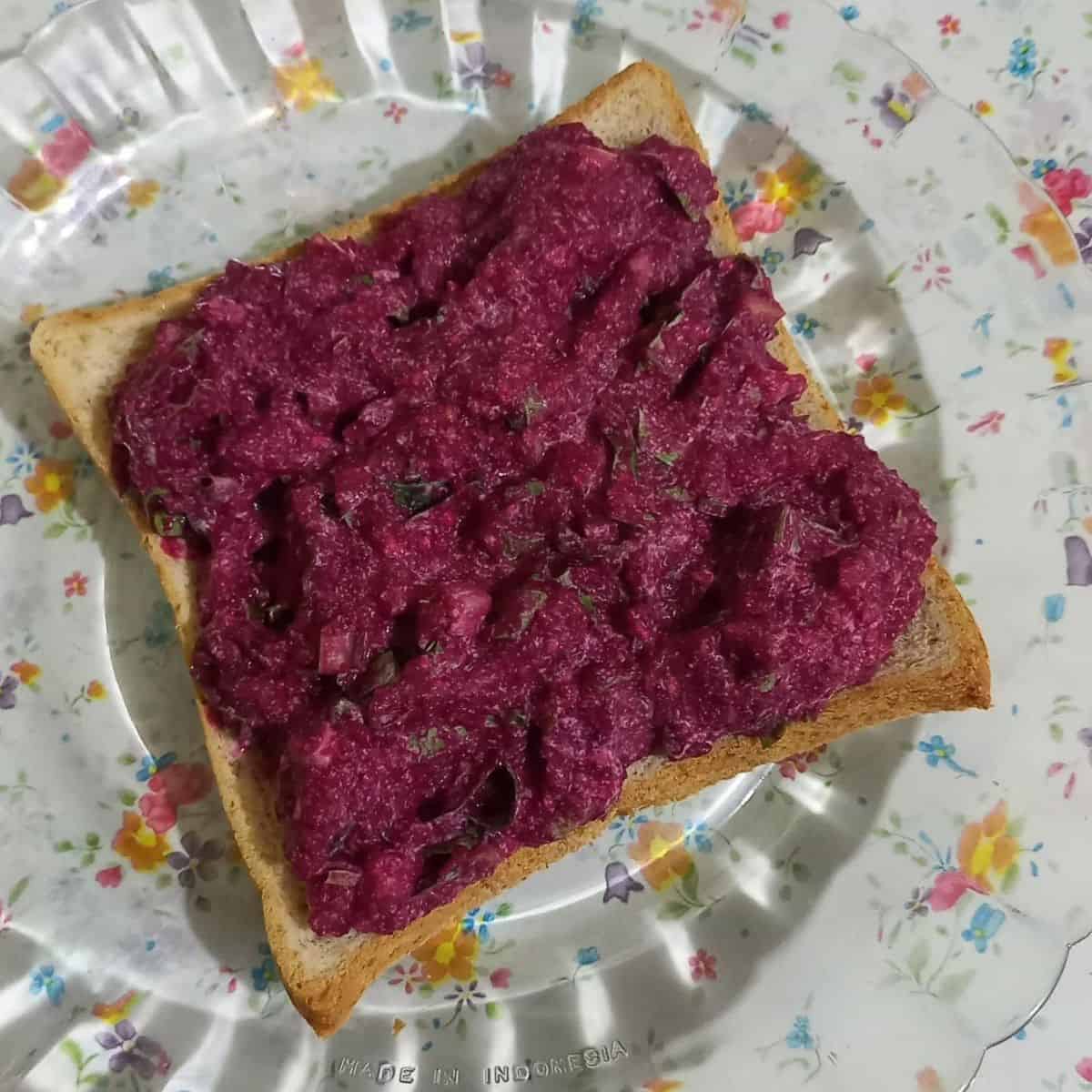Beetroot spread on a piece of toast.