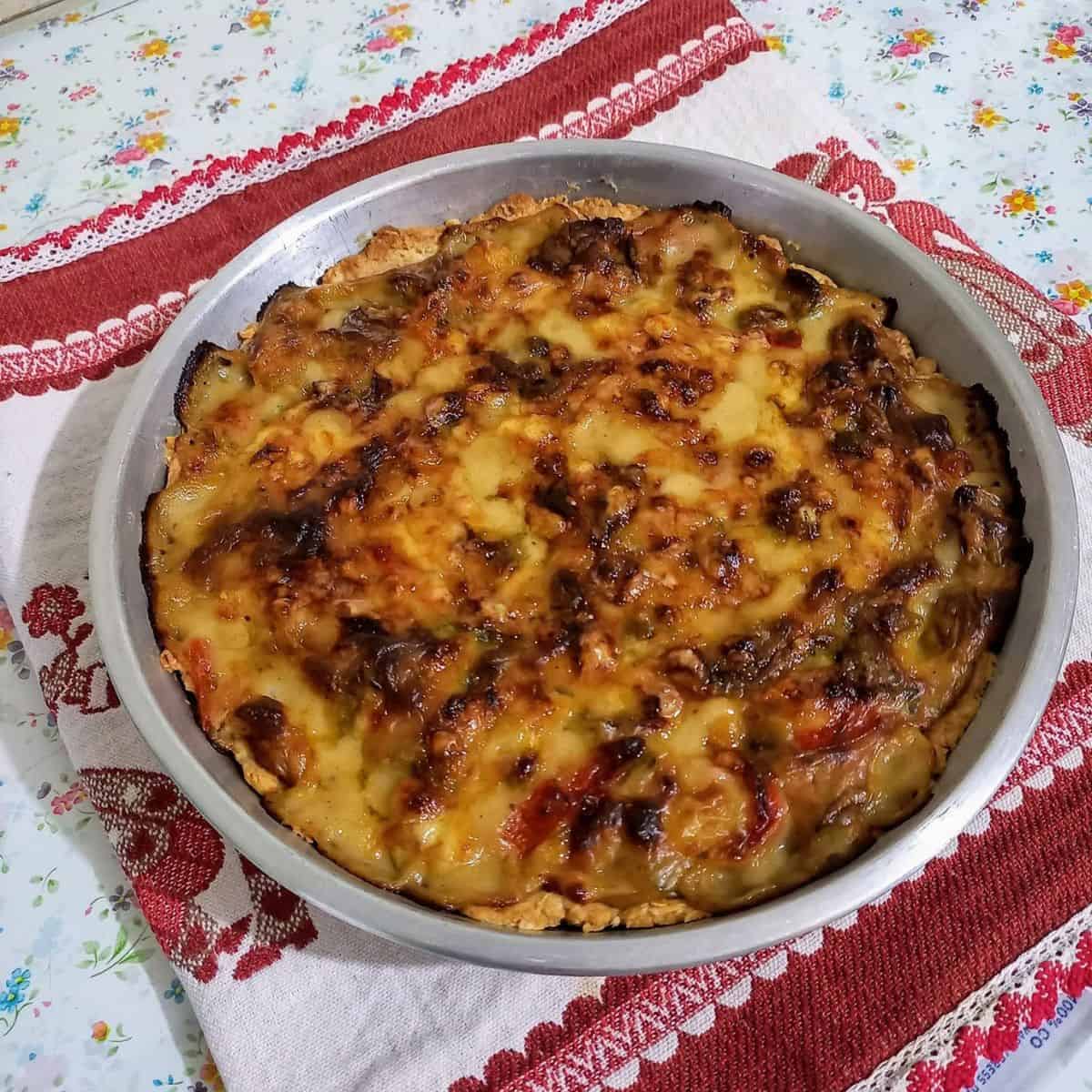 Cheesy vegetable pie in a dish.