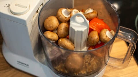 Mushrooms, peppers, red onion and walnuts in a food processor.